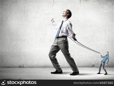 Businessman struggling with problems that occur on the way. Bound with responsibility