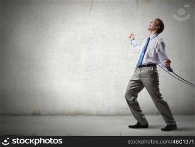 Businessman struggling with problems that occur on the way. Bound with responsibility