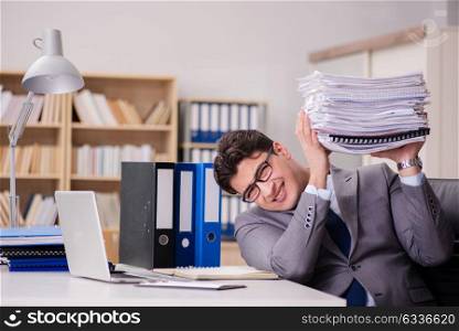 Businessman struggling with stacks of papers