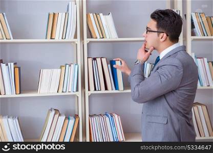 Businessman student reading a book studying in library