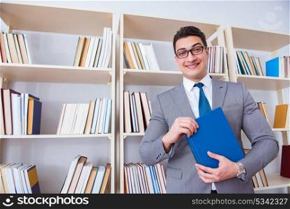 Businessman student reading a book studying in library