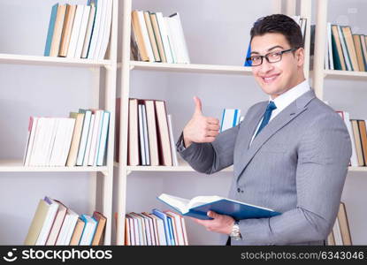 Businessman student reading a book studying in library