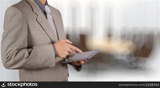 businessman success using tablet computer with his board room background