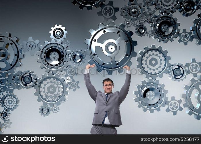Businessman supporting gear in teamwork concept