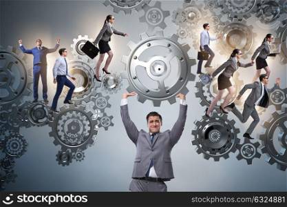 Businessman supporting gear in teamwork concept