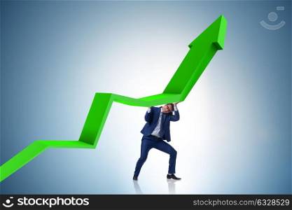 Businessman supporting growtn in economy on chart graph. The businessman supporting growtn in economy on chart graph