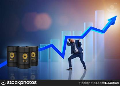 Businessman supporting oil price in business concept