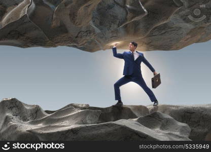 Businessman supporting stone under pressure