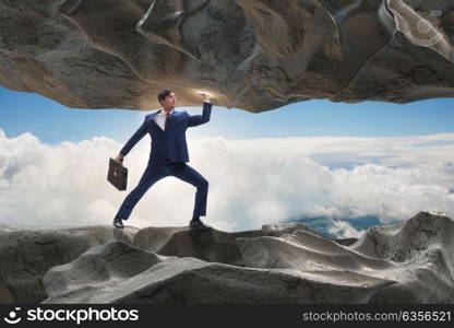 Businessman supporting stone under pressure