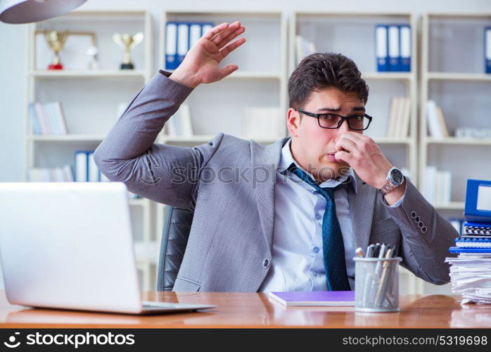 Businessman sweating excessively smelling bad in office at workp. Businessman sweating excessively smelling bad in office at workplace