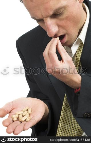 Businessman taking a pill to get rid of his depression
