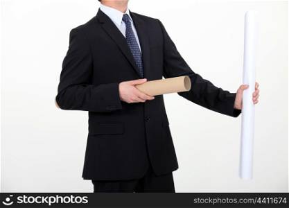 Businessman taking a rolled up plan out of its case