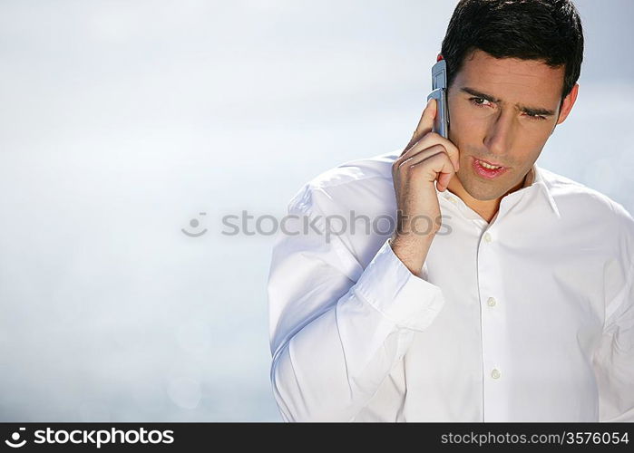 Businessman taking at call whilst at the beach