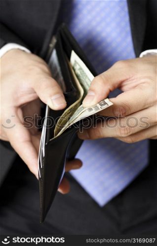 Businessman taking money out of his wallet