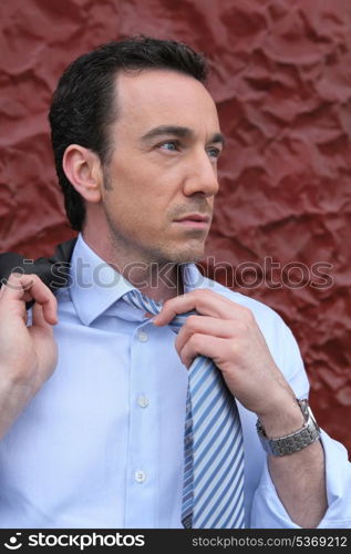 businessman taking off his tie