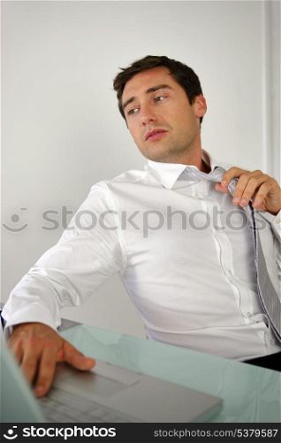 businessman taking off his tie