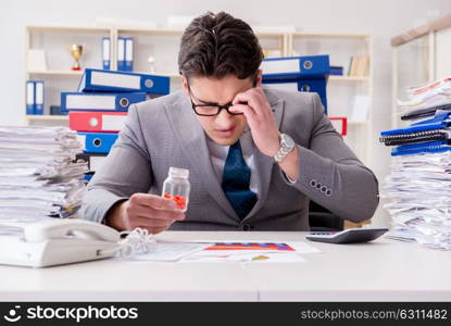 Businessman taking pills to cope with stress