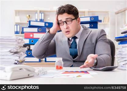 Businessman taking pills to cope with stress