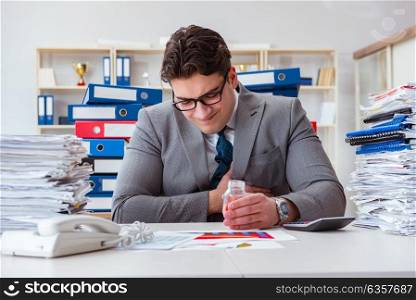 Businessman taking pills to cope with stress