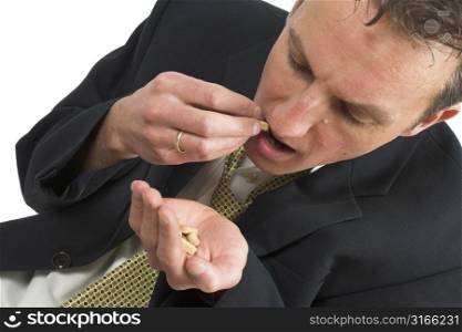 Businessman taking some pills to get him through the day