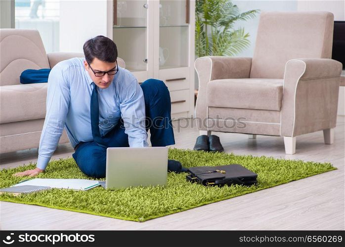 Businessman taking work home and working overtime