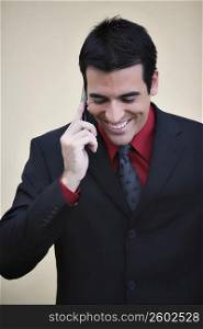 Businessman talking on a mobile phone and smiling