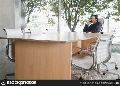 Businessman talking on a mobile phone in a conference room
