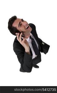 businessman talking on his cell and laughing