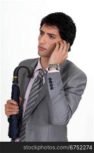 businessman talking on his cell and looking serious