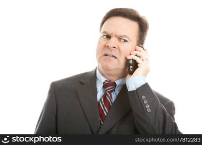 Businessman talking on his cellphone. Very expressive worried face. Isolated on white.