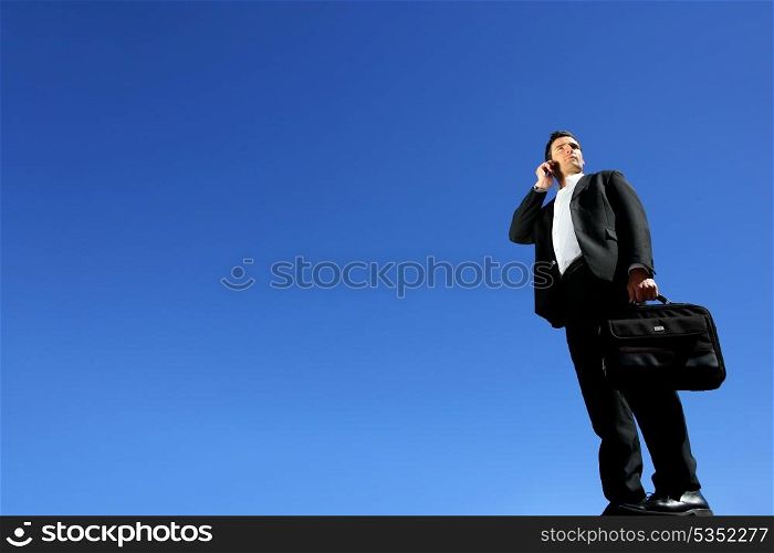 Businessman talking on his mobile phone on a sunny day