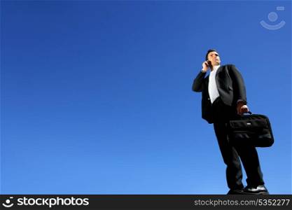 Businessman talking on his mobile phone on a sunny day