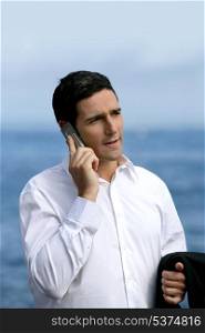 Businessman talking on his mobile phone outside