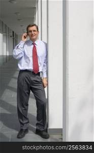 Businessman talking on mobile phone at aa office building