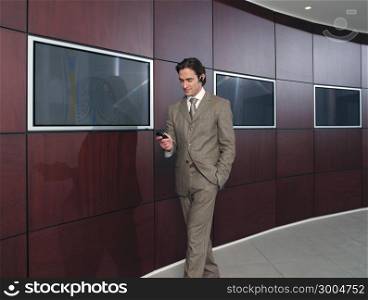 Businessman talking on mobile phone in office lobby