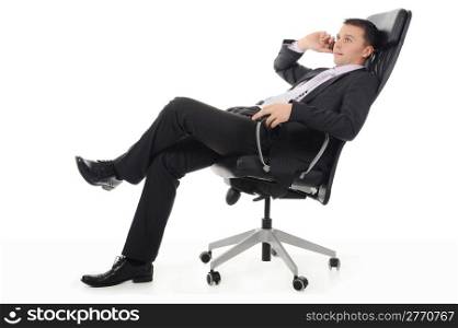 Businessman talking on the phone sitting in a chair in a bright office. Isolated on white background