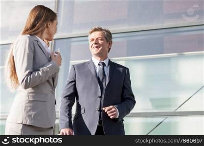 Businessman talking to businesswoman in airport