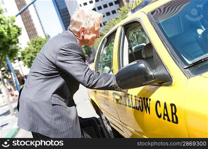 Businessman talking to taxi driver