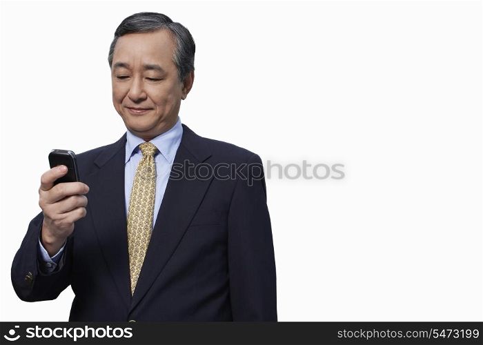 Businessman text messaging on cell phone over white background