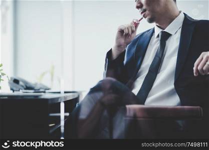 Businessman thinking Ideas sitting at his desk in a office .