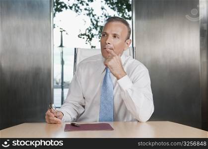 Businessman thinking in a board room