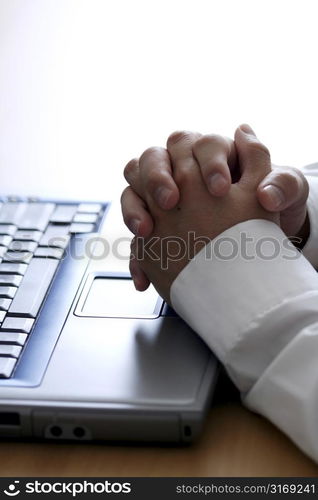 Businessman thinking while working on a laptop