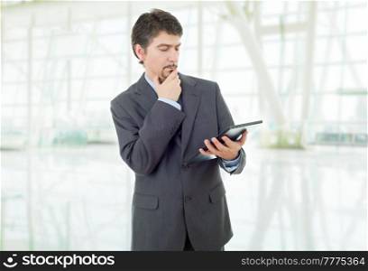 businessman thinking with a tablet pc, at the office