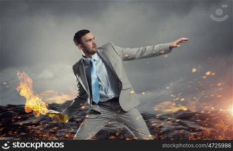 Businessman throwing petrol bomb. Aggressive businessman in suit throwing burning molotov cocktail