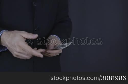 Businessman throws money into camera