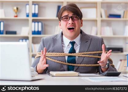 Businessman tied up with rope in office. The businessman tied up with rope in office