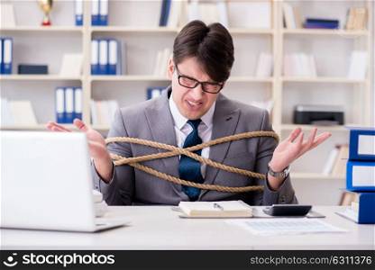 Businessman tied up with rope in office. The businessman tied up with rope in office