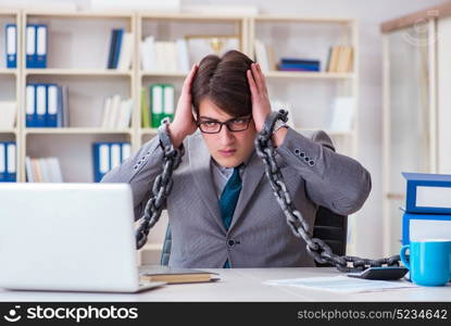 Businessman tied with chains to his work