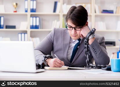 Businessman tied with chains to his work