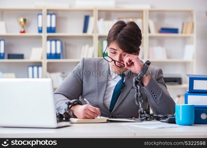 Businessman tied with chains to his work